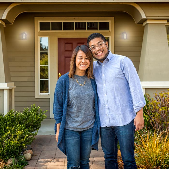 couple standing outside of new home