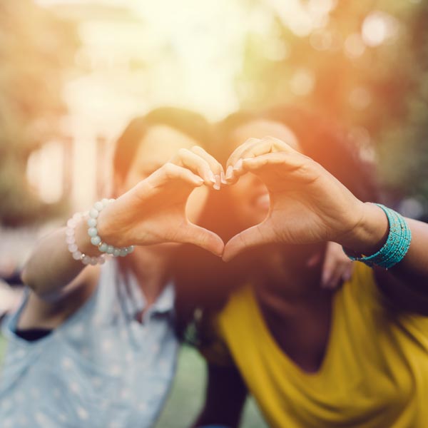 two people making a heart with their hands